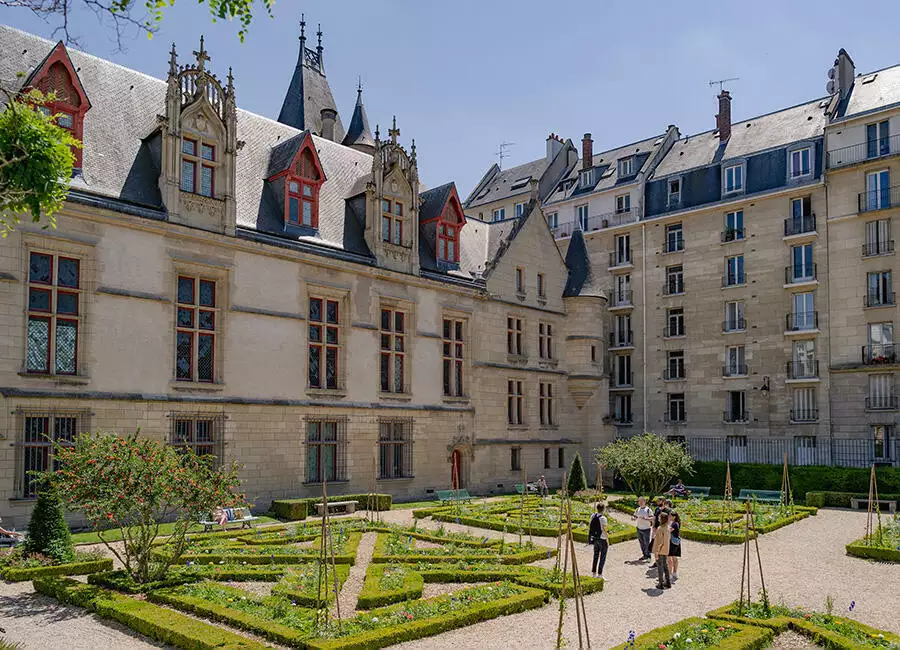 Walking through a garden on the Marais tour