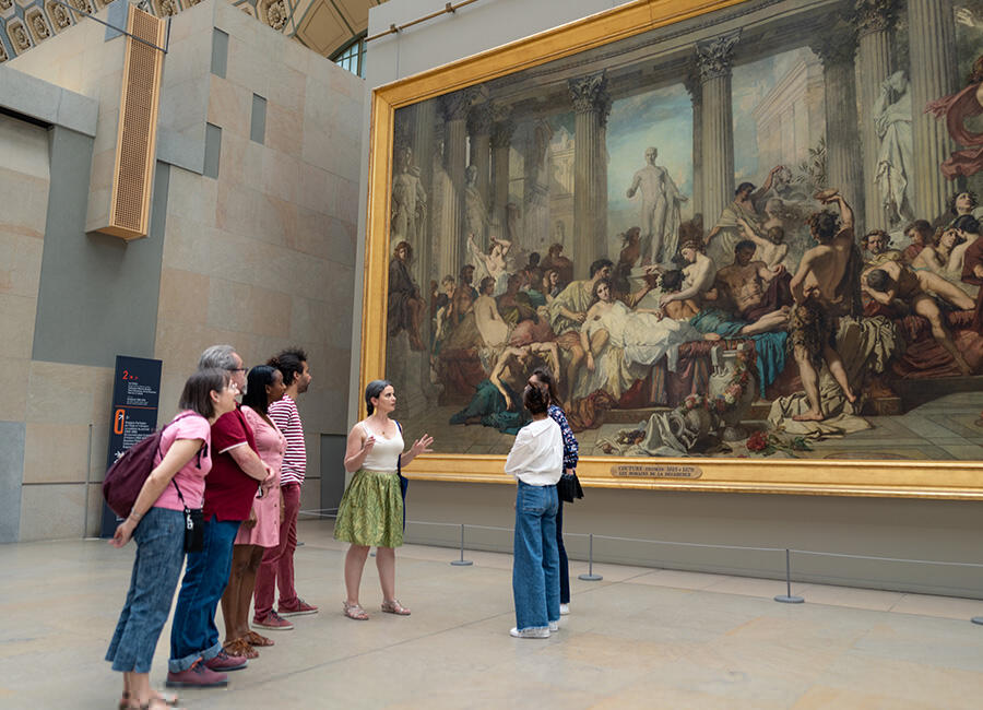 A guide sharing the history of a painting on the Musee dOrsay Tour